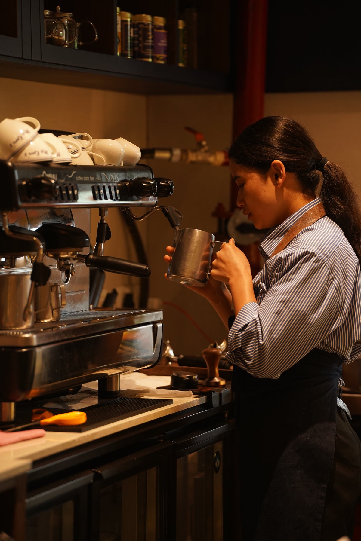 A Mrs Kaur’s barista steaming milk at the espresso machine