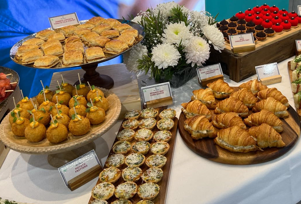A Mrs Kaur’s grazing table with potato fritters, spinach and corn quiches, mini chicken salad croissants, filo pastries and mini chocolate tarts