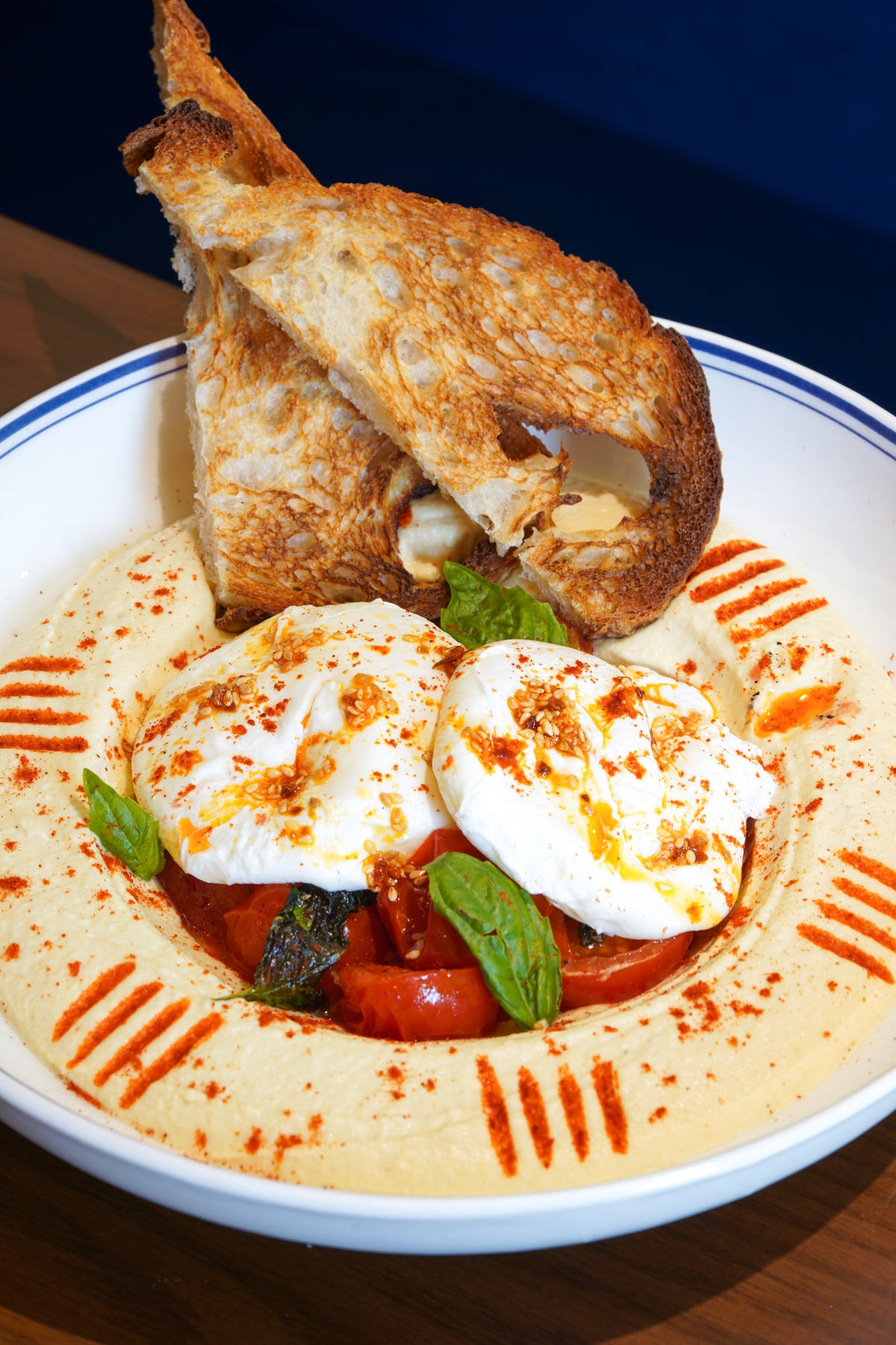 Hummus Eggs Levantine at Mrs Kaur’s: poached eggs and roasted tomatoes on a bed of hummus