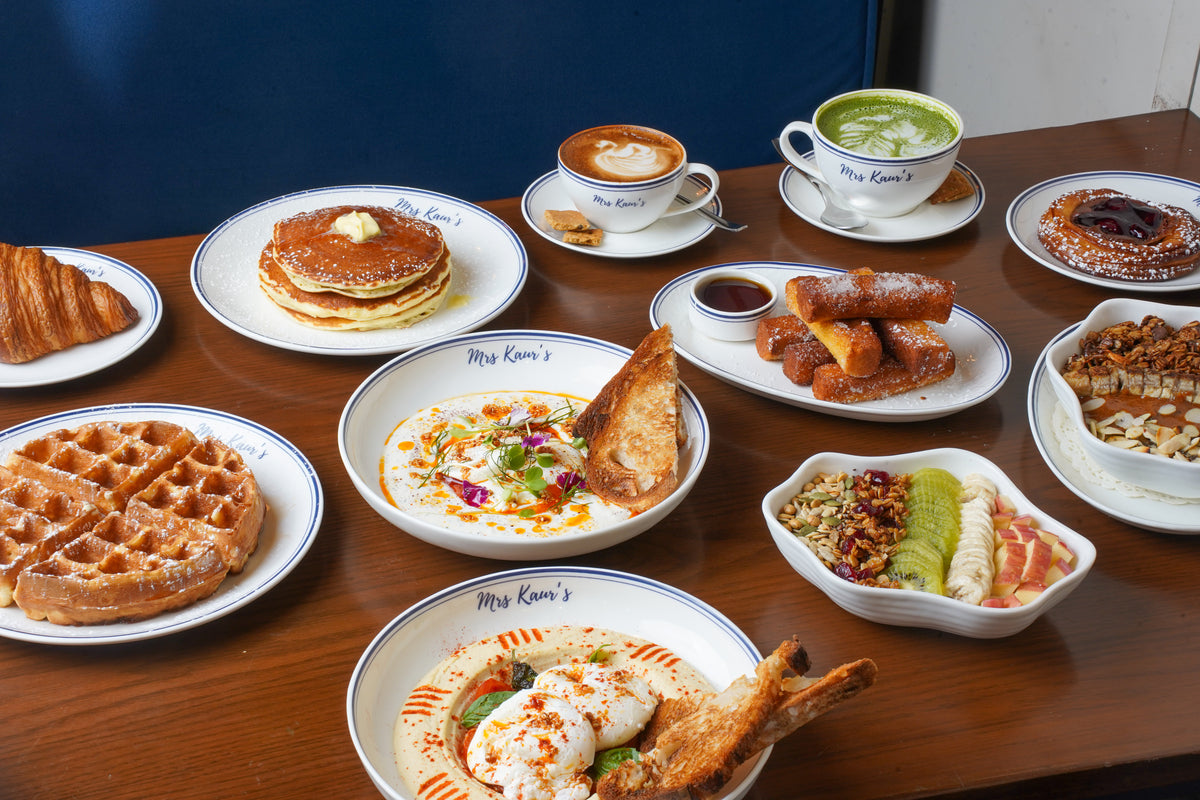 A brunch table at Mrs Kaur’s: pancakes, waffles, eggs, coffee and matcha on Mrs Kaur’s crockery